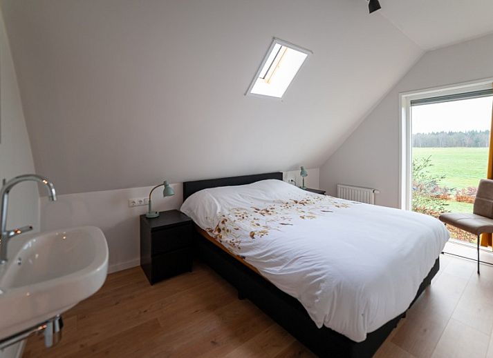 Cozy indoor space of The Buzzard vacation rental in Punthorst, Overijssel overlooking nature.