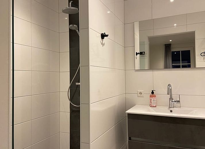 Modern living room in Holiday home in Dalfsen, Vechtstreek, Overijssel with comfortable chairs and stylish kitchen.