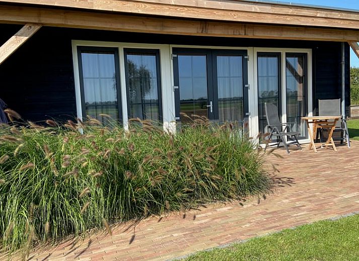 Modern living room in Holiday home in Dalfsen, Vechtstreek, Overijssel with comfortable chairs and stylish kitchen.