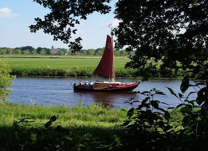 Dining area in Holiday Home in Dalfsen, Overijssel, with large window overlooking the Vecht region and the water.