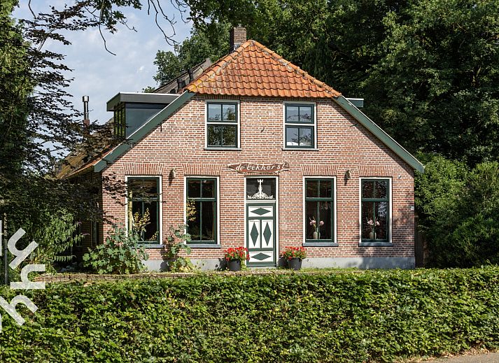 OV188 vacation home in Balkbrug, Vecht region, offers a charming brick facade surrounded by lush nature.