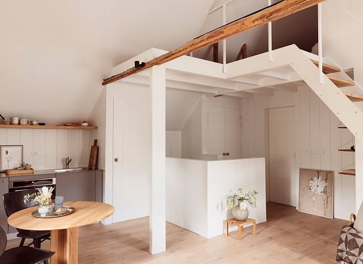 Gemuetliches Wohnzimmer von Huisje in Rheeze, Ferienhaus in der Region Vecht in Overijssel, mit Holzbalken und modernen Moebeln.