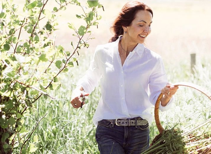 Gemuetliches Wohnzimmer von Huisje in Rheeze, Ferienhaus in der Region Vecht in Overijssel, mit Holzbalken und modernen Moebeln.