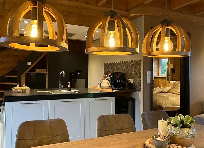 Cozy indoor area of Holiday Home in Giethmen, Overijssel, with atmospheric lighting and modern kitchen.