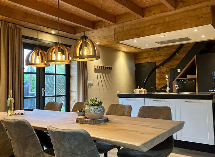Cozy indoor area of Holiday Home in Giethmen, Overijssel, with atmospheric lighting and modern kitchen.