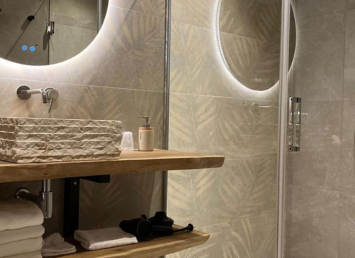 Cozy indoor area of Holiday Home in Giethmen, Overijssel, with atmospheric lighting and modern kitchen.