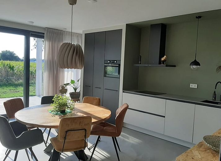 Cozy terrace at Holiday home in Lemele, ideal for outdoor dining overlooking the green surroundings of the Vecht region.