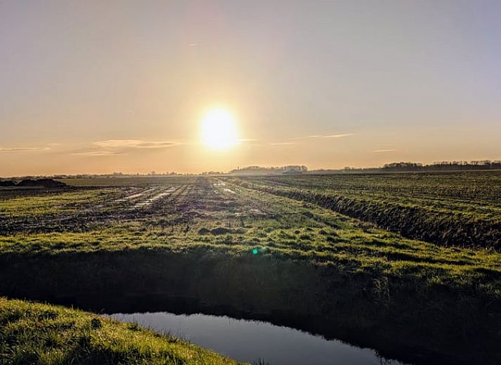 Kitchen corner in Holiday Home in De Krim, Overijssel with table and cupboard.