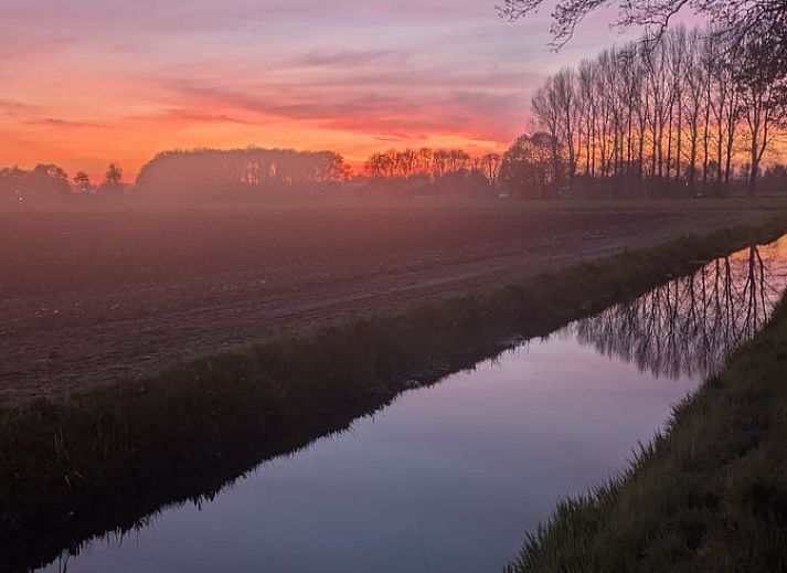 Kitchen corner in Holiday Home in De Krim, Overijssel with table and cupboard.