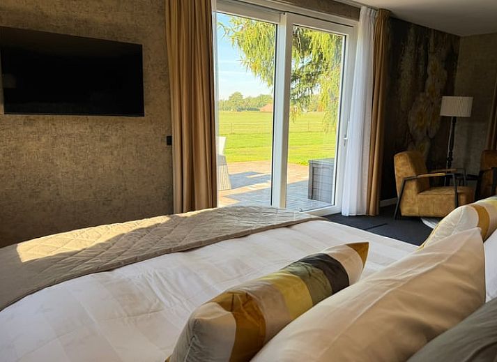 Cozy sitting area with fireplace in Cottage in Kloosterhaar, Vechtstreek, Overijssel.