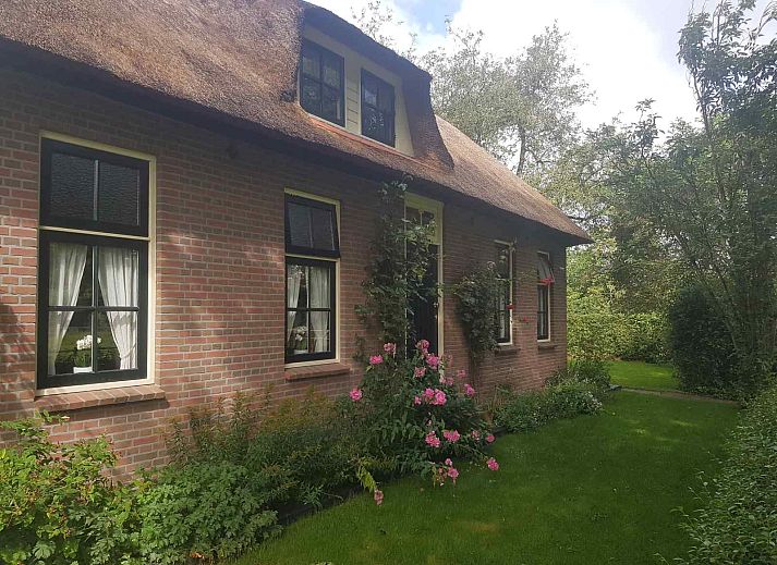 Bedroom in OV602 vacation home in Giethoorn with comfortable beds and skylight.