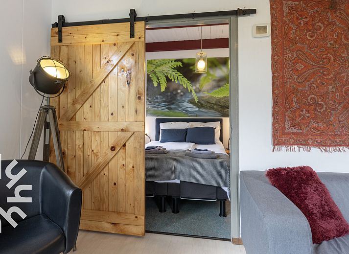 Attractive bedroom in vacation home OV480 in Giethoorn, Overijssel, with comfortable bed and view of green nature.