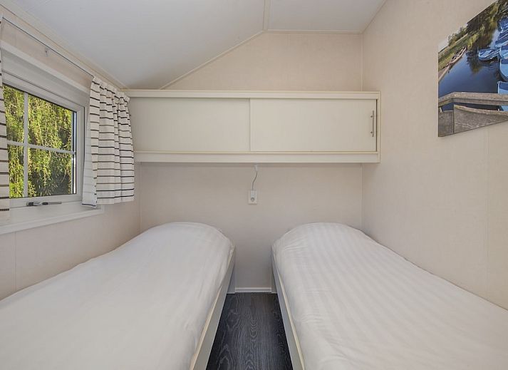 Porch of Tiny House 2 chalet in Giethoorn, Northwest Overijssel, surrounded by green nature and rustic charm.