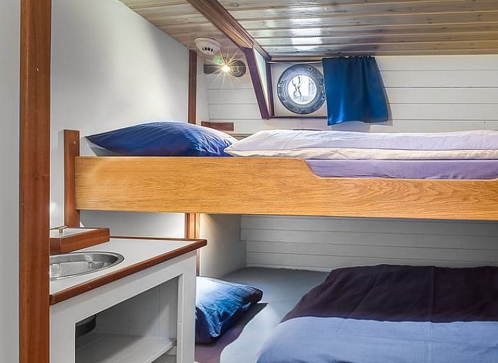 Cozy dining area in Holiday Home in Zwartsluis, Northwest Overijssel, with wooden interior and comfortable seating area.