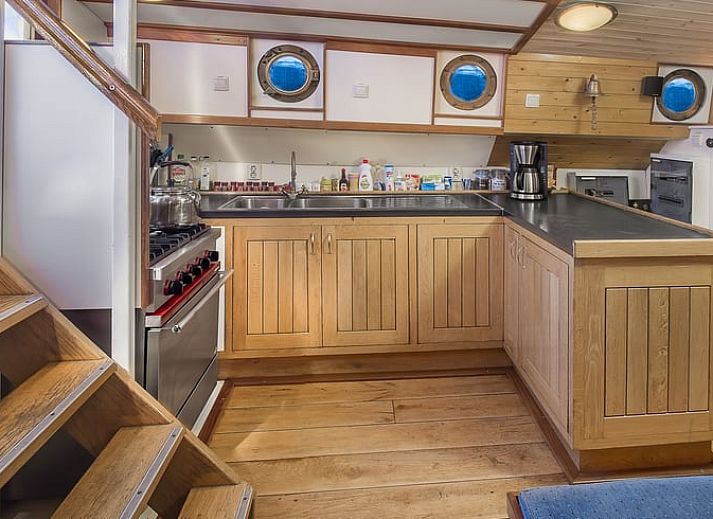 Cozy dining area in Holiday Home in Zwartsluis, Northwest Overijssel, with wooden interior and comfortable seating area.