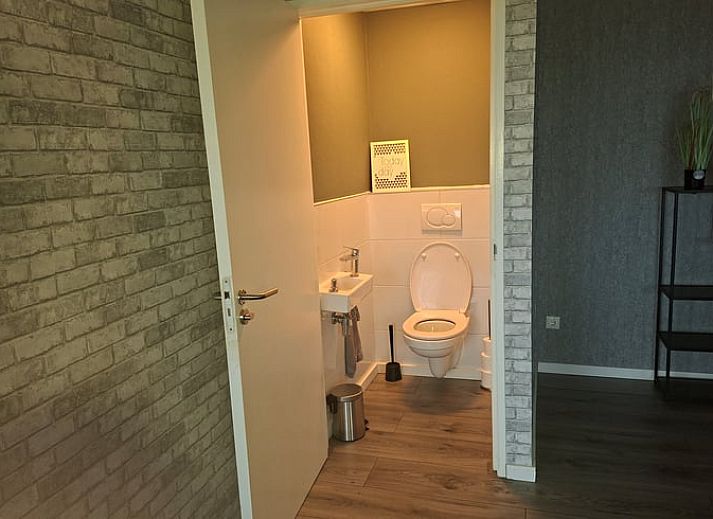 Cozy living room of Holiday home in Zwartsluis, Overijssel, with comfortable seating area and views of the serene nature.