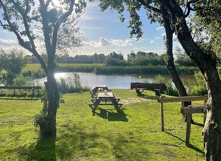 Cozy living room of Holiday home in Zwartsluis, Overijssel, with comfortable seating area and views of the serene nature.