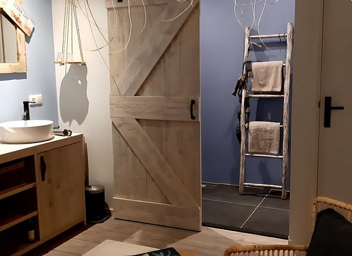 Blooming flowers and a peaceful pond at Holiday Home in De Bult, Overijssel, offer picturesque views from the terrace.