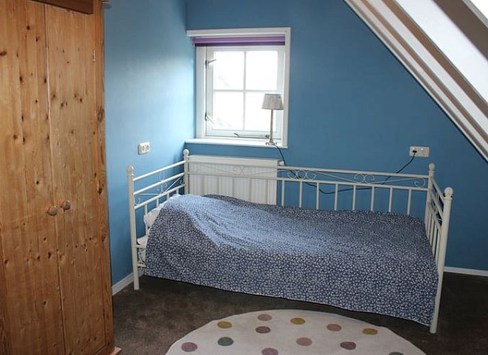 Cozy living room with hanging chair in Cottage in Wanneperveen, vacation accommodation in Overijssel.