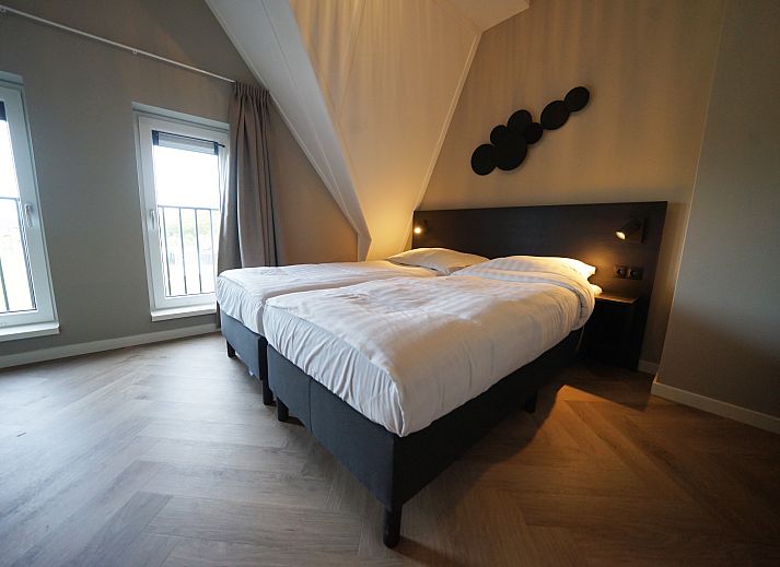 Bright living room in Chalet in Kampen, Overijssel, with comfortable seating area and views of nature.