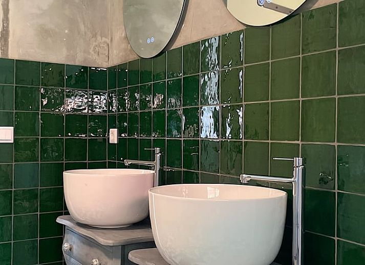 Modern kitchen in Holiday Home in IJhorst, Northwest Overijssel, with stylish tiles and practical furnishings for a comfortable stay.