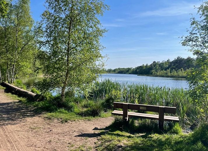 Modern kitchen in Holiday Home in IJhorst, Northwest Overijssel, equipped with stylish tile wall and modern appliances.