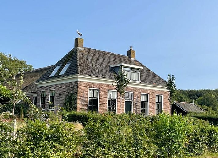 Modern kitchen in Holiday Home in IJhorst, Northwest Overijssel, equipped with stylish tile wall and modern appliances.