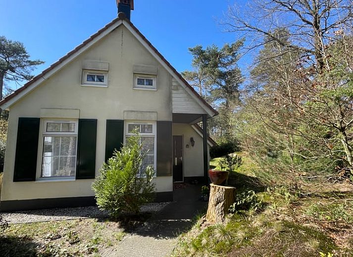 Dining room of Holiday home in IJhorst overlooking green garden, ideal for cozy meals.