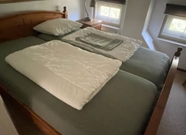 Dining room of Holiday home in IJhorst overlooking green garden, ideal for cozy meals.