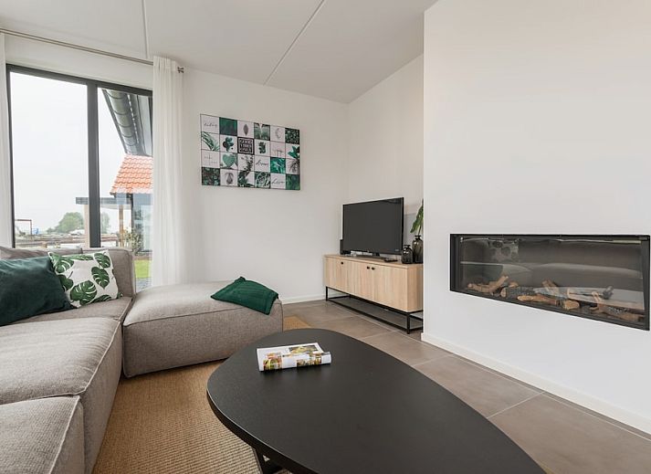 Lichte woonkamer in Watervilla 8, een vakantiehuis in Ossenzijl, Noordwest Overijssel, met uitzicht op het water en moderne inrichting.