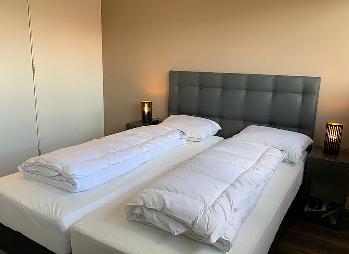 Bedroom in Family Villa 12, a vacation home in Ossenzijl, Overijssel, with views of nature through large windows.