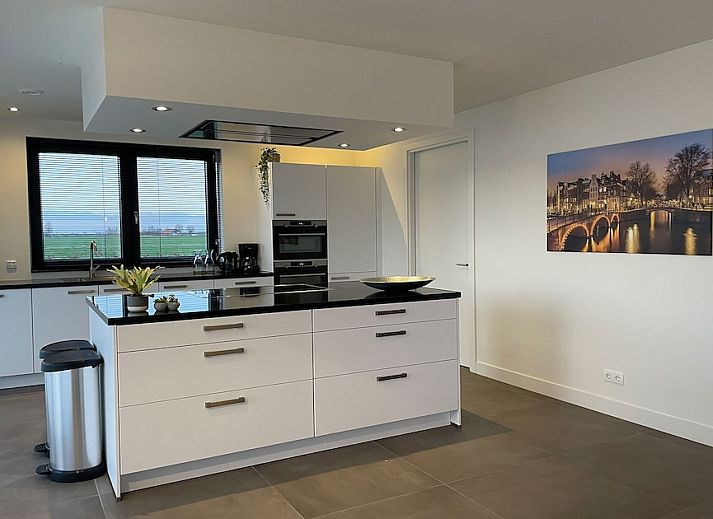 Bedroom in Family Villa 12, a vacation home in Ossenzijl, Overijssel, with views of nature through large windows.