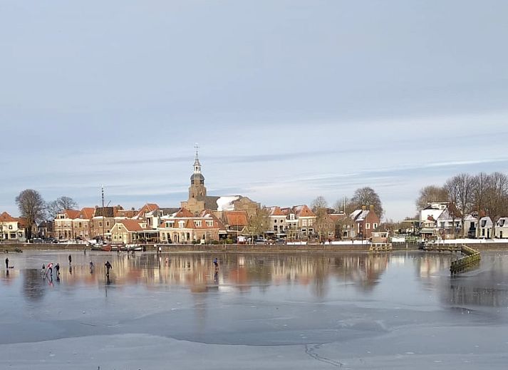 Picturesque view of frozen water and historic buildings in Blokzijl, near OV686 vacation home.