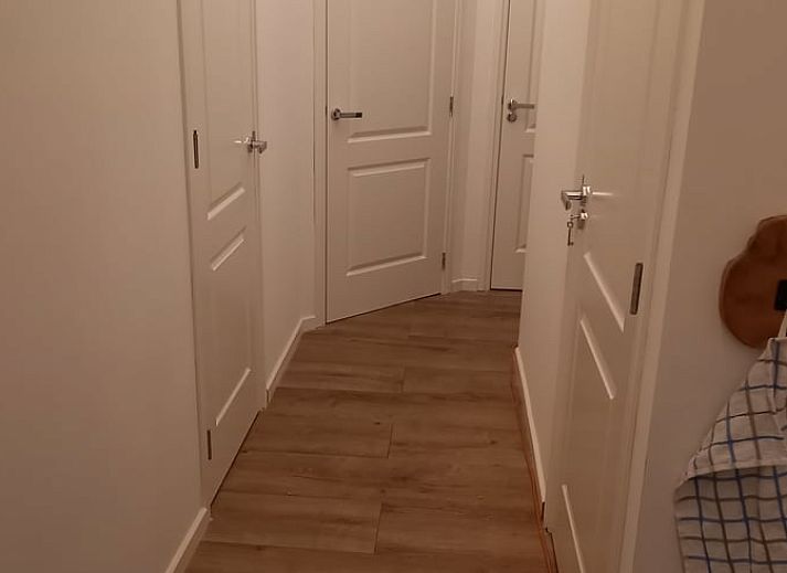 Green garden overlooking the water at Holiday home in IJsselmuiden, ideal for relaxation.