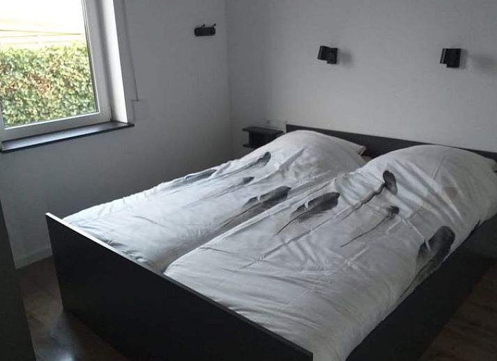 Green garden overlooking the water at Holiday home in IJsselmuiden, ideal for relaxation.