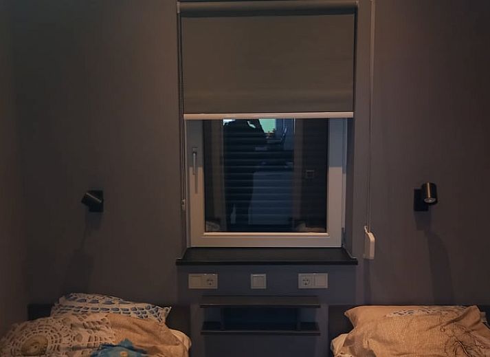 Green garden overlooking the water at Holiday home in IJsselmuiden, ideal for relaxation.