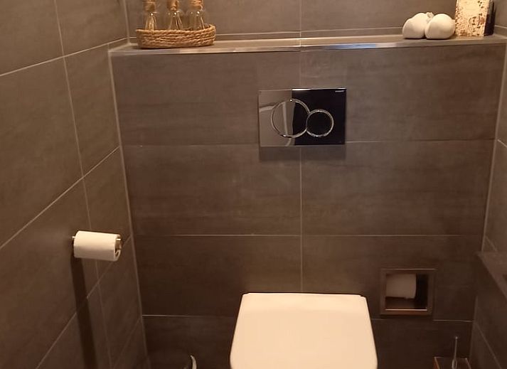 Green garden overlooking the water at Holiday home in IJsselmuiden, ideal for relaxation.