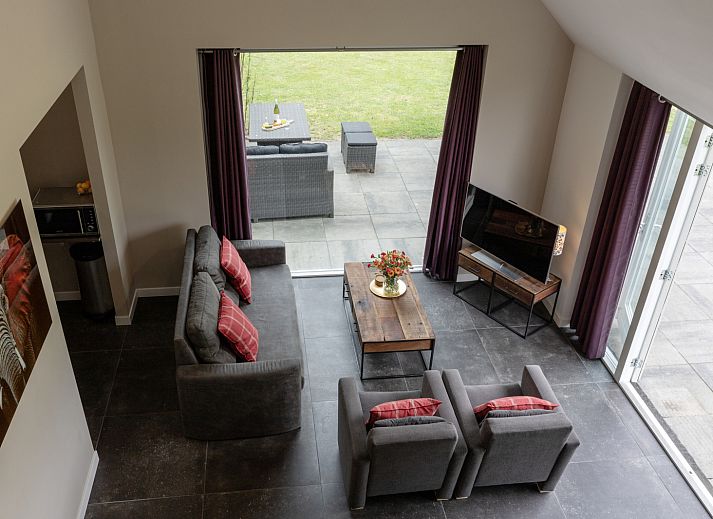 Cozy indoor area of vacation home OV473 in Baars, Overijssel, with a cozy sitting area and views of green nature.