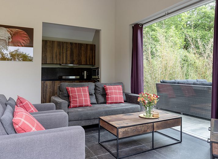 Cozy indoor area of vacation home OV473 in Baars, Overijssel, with a cozy sitting area and views of green nature.