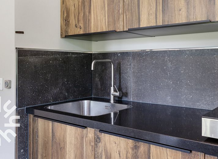 Cozy indoor area of vacation home OV473 in Baars, Overijssel, with a cozy sitting area and views of green nature.