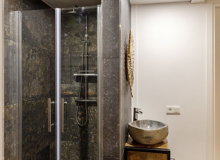 Cozy indoor area of vacation home OV473 in Baars, Overijssel, with a cozy sitting area and views of green nature.