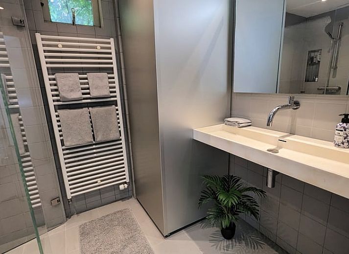 Stijlvolle woonkamer in Vakantiehuis in Soest met uitzicht op de groene natuur van Utrecht.