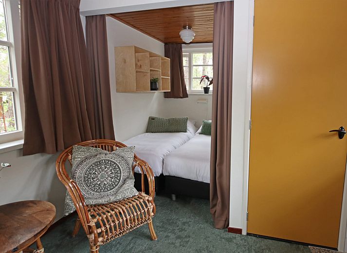 Gezellige zithoek in Bungalow Ficus, Doorn, Utrechtse Heuvelrug met uitzicht op de natuur.