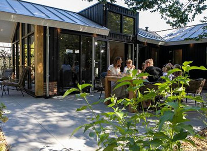Cozy terrace at Holiday Home De Thijmse Berg, Rhenen, Utrechtse Heuvelrug ideal for family dinners.