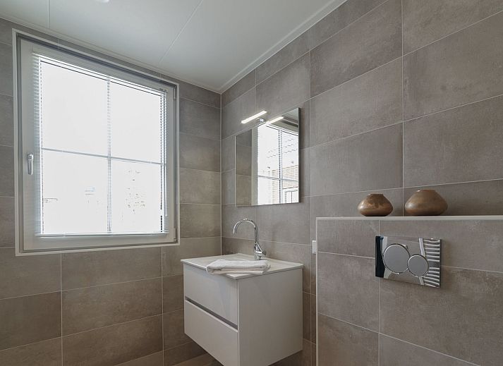 Dining room with wooden table in Holiday Home Ganuenta, Colijnsplaat, North Beveland, ideal for cozy dinners.