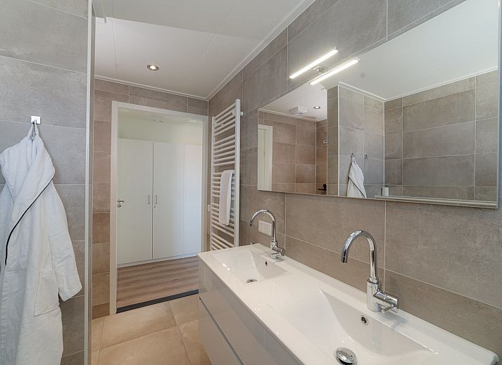 Dining room with wooden table in Holiday Home Ganuenta, Colijnsplaat, North Beveland, ideal for cozy dinners.