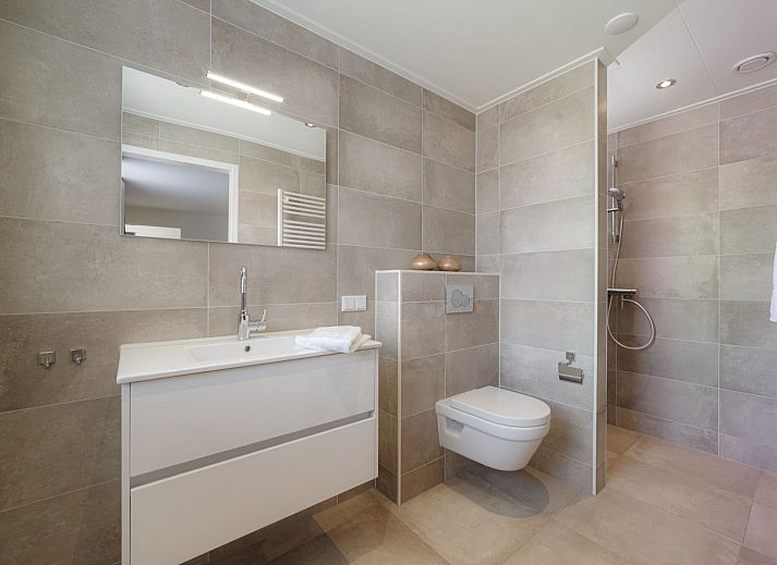 Dining room with wooden table in Holiday Home Ganuenta, Colijnsplaat, North Beveland, ideal for cozy dinners.