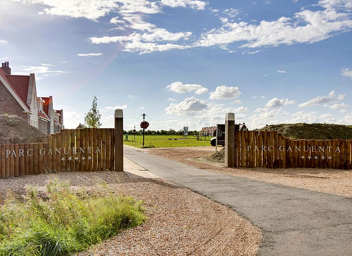 Comfortable bedroom in Holiday Home Ganuenta, Colijnsplaat, Noord-Beveland with ensuite bathroom.