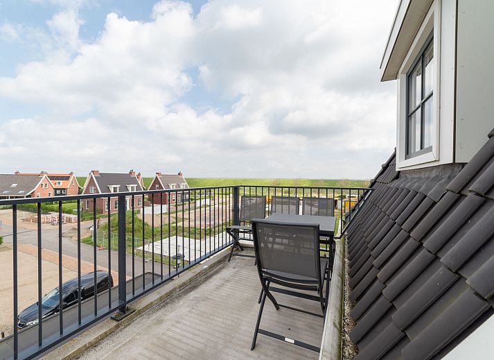 Charmanter Aussenbereich des Apartments Ganuenta in Colijnsplaat, Nord-Beveland, mit roten Ziegeln und bluehenden Blumen.