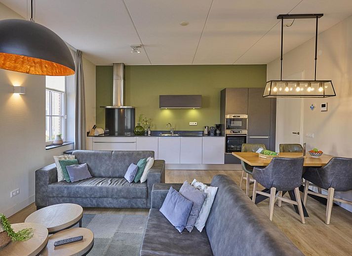 Sauna Zee vacation home in Colijnsplaat, Zeeland with a charming facade and beautiful flower garden.